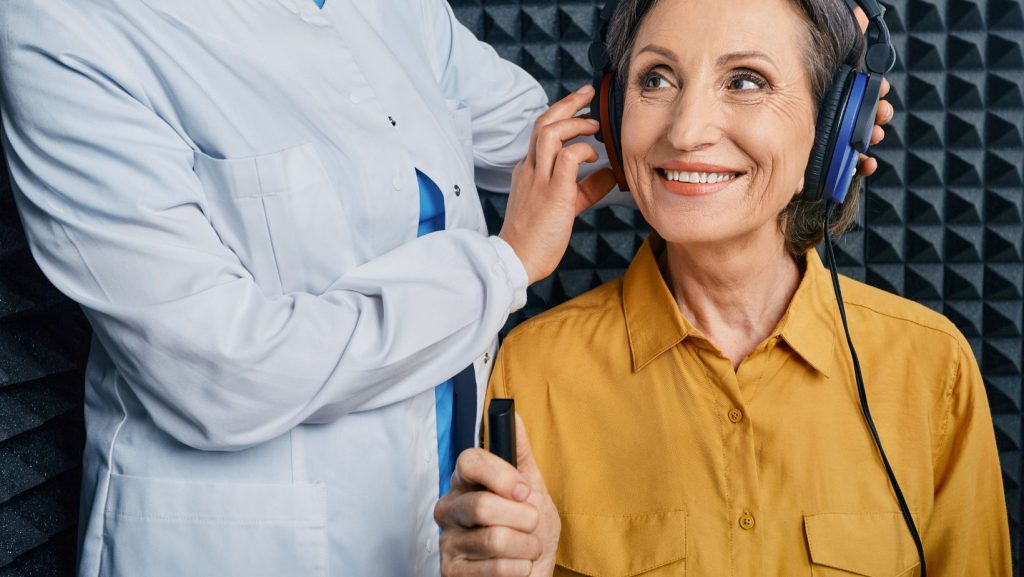 a person wearing Hearing test headphones and smiling