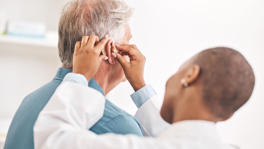 Hearing aid being repaired