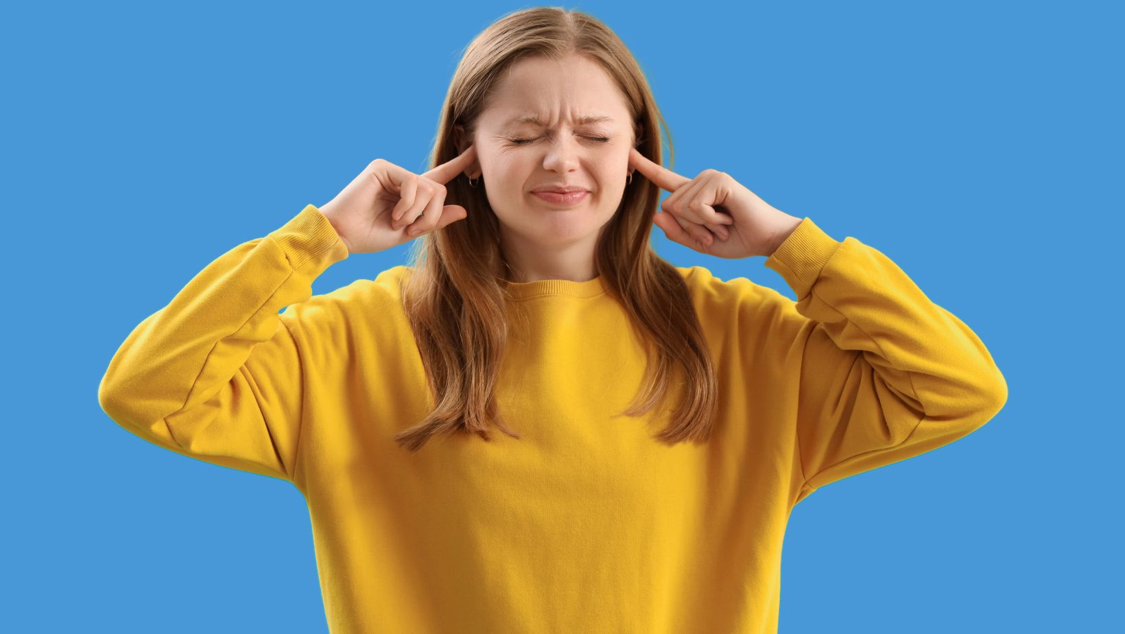 Girl plugging her ears