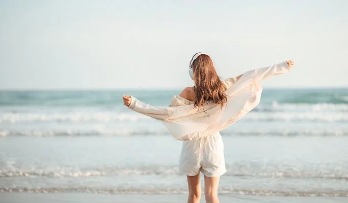 Hearing Health a girl standing and watching towards the ocean