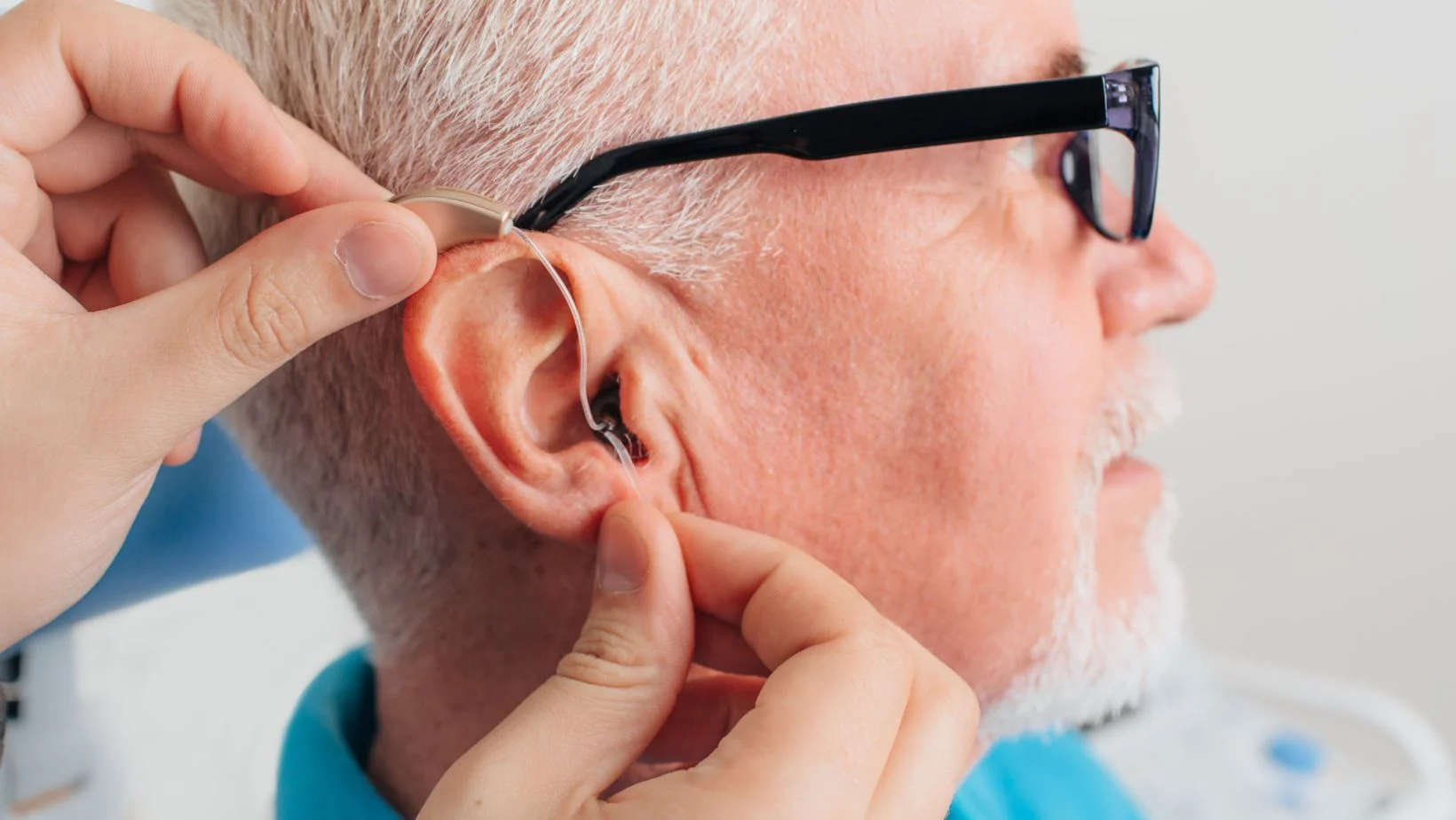 a man getting fitted for a hearing aid