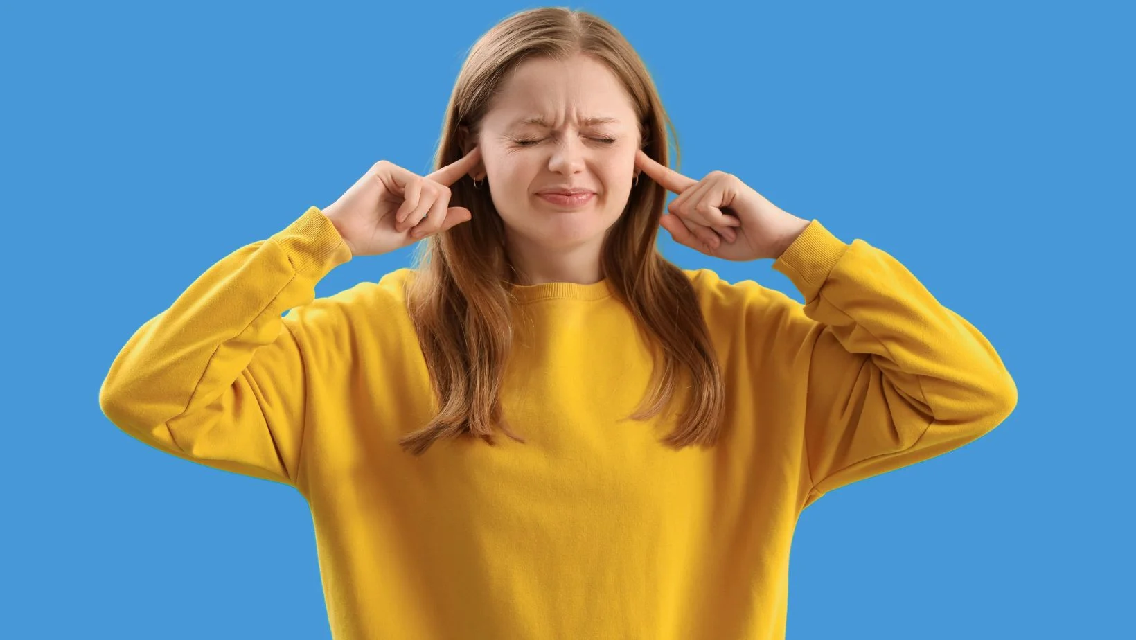 Girl plugging her ears